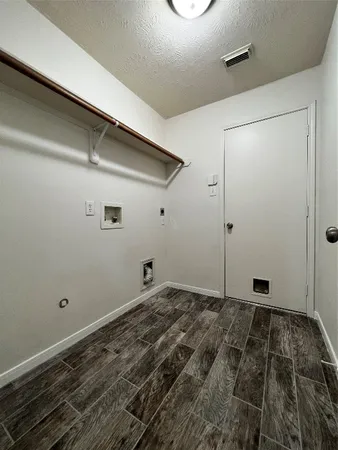 a view of a room with wooden floor