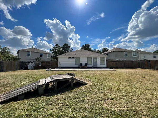 a house view with a swimming pool and a yard