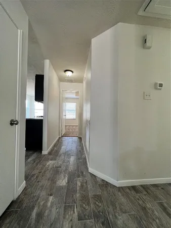 a view of hallway with wooden floor