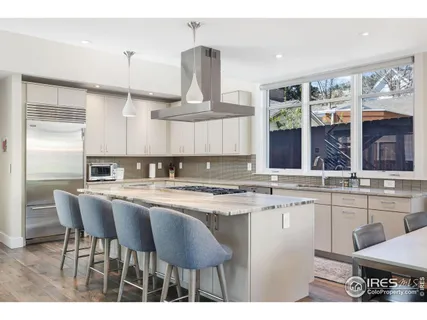 a kitchen with stainless steel appliances a sink and cabinets