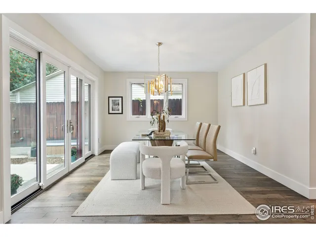 a view of a dining room with furniture wooden floor and chandelier