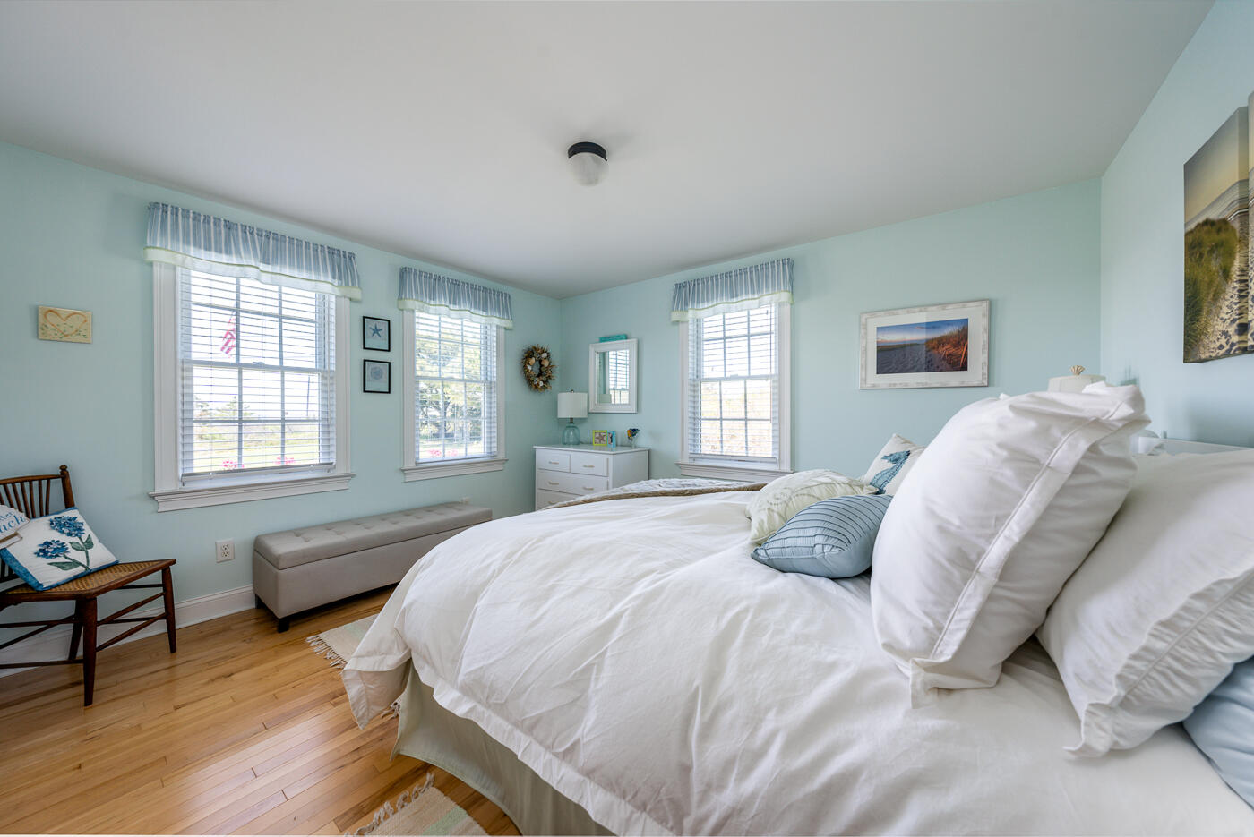 16 Bay View Road Truro, MA 02666 - Photo 28 of 57 a bedroom with a bed wooden floor and windows
