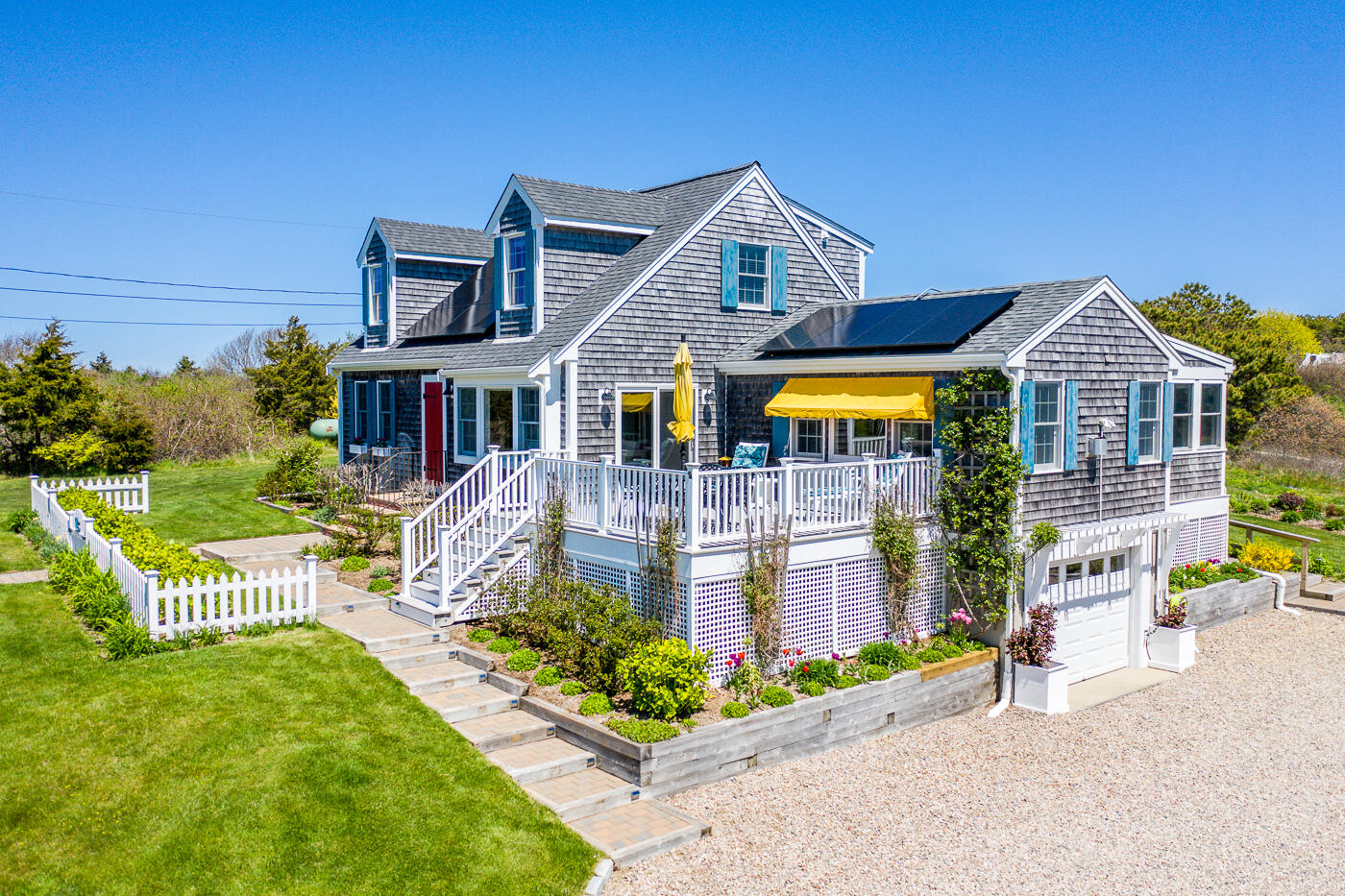 16 Bay View Road Truro, MA 02666 - Photo 3 of 57 a front view of a house with a yard