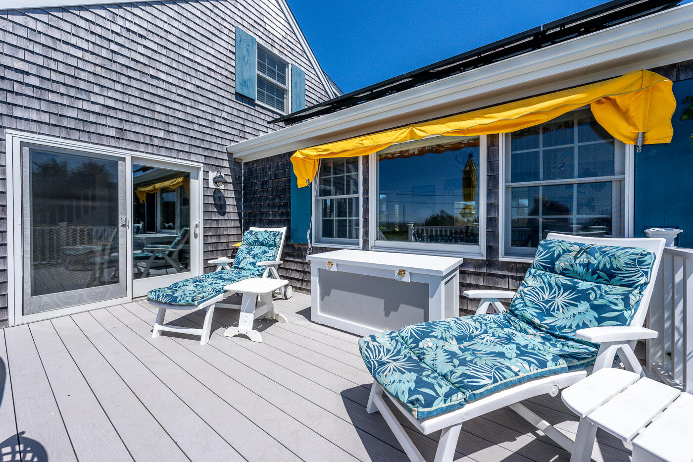 16 Bay View Road Truro, MA 02666 - Photo 43 of 57 a view of a patio with table and chairs with wooden floor and fence