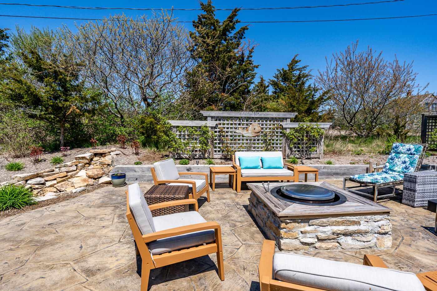 16 Bay View Road Truro, MA 02666 - Photo 8 of 57 a view of a patio with couches chairs and a fire pit