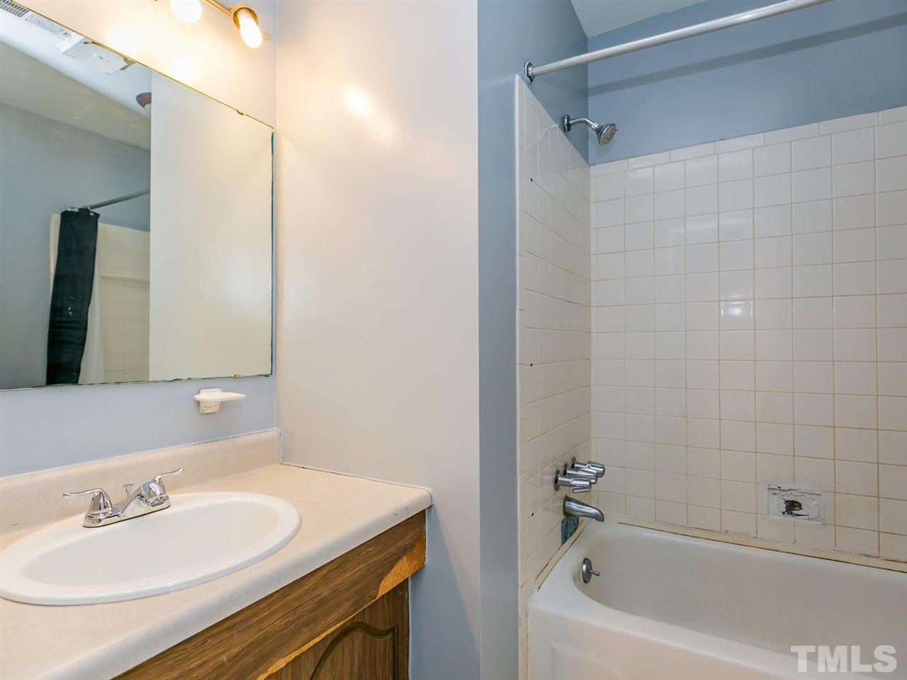 1722 Quail Ridge Road Raleigh, NC 27609 - Photo 14 of 28 a bathroom with a sink and a bathtub