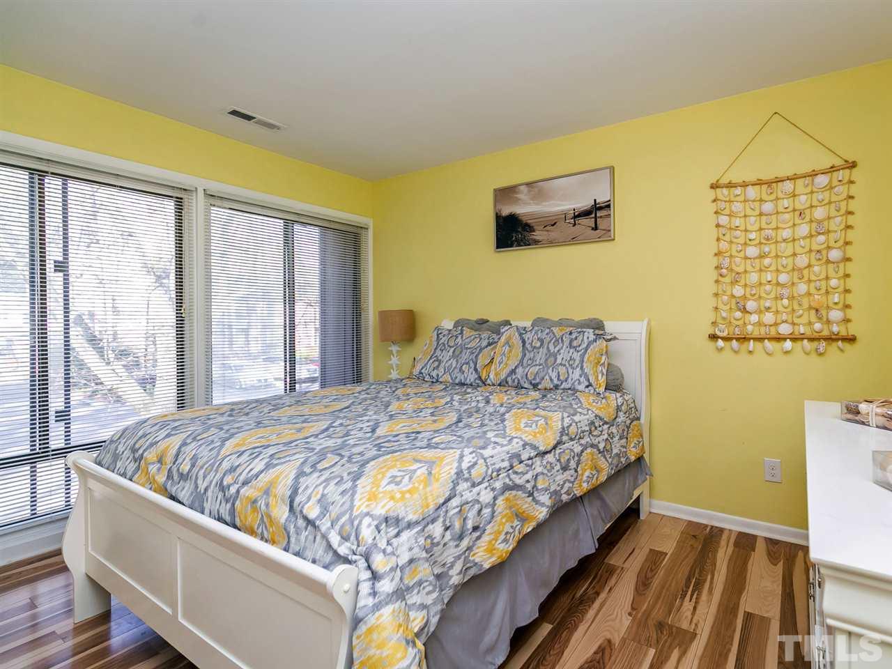 1722 Quail Ridge Road Raleigh, NC 27609 - Photo 15 of 28 a bed sitting in a bedroom next to a window
