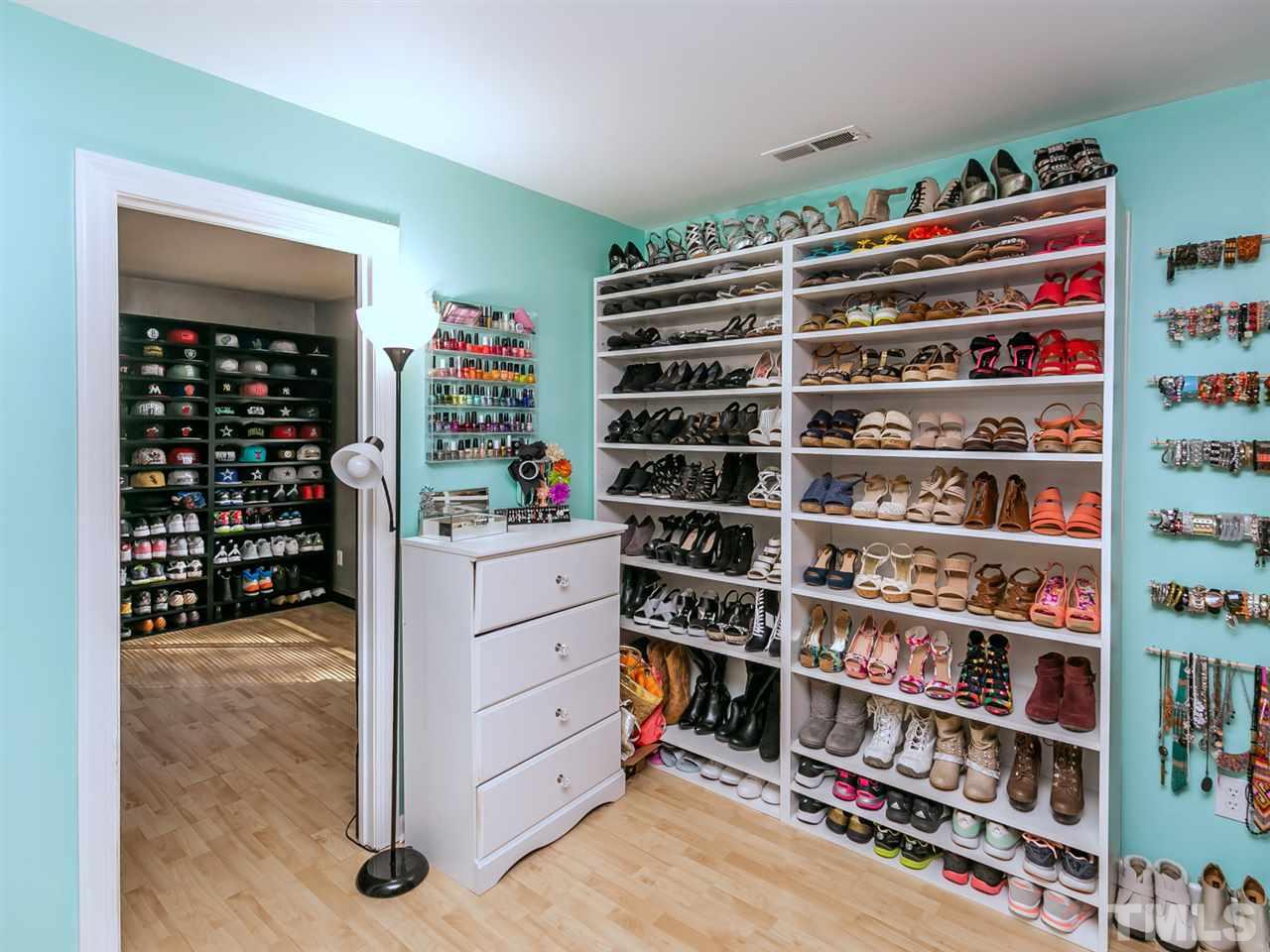 1722 Quail Ridge Road Raleigh, NC 27609 - Photo 18 of 28 a room with a book shelf and a closet