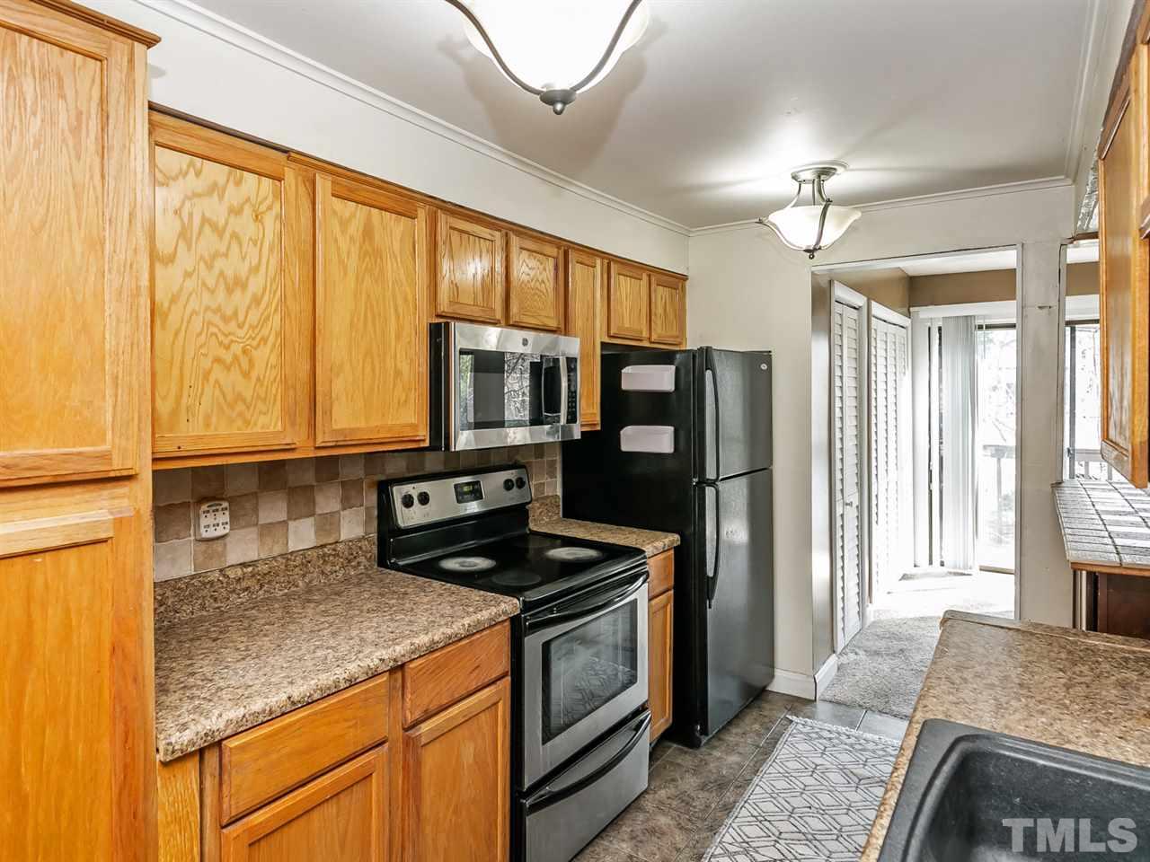 1722 Quail Ridge Road Raleigh, NC 27609 - Photo 4 of 28 a kitchen with stainless steel appliances granite countertop a stove a sink and a refrigerator