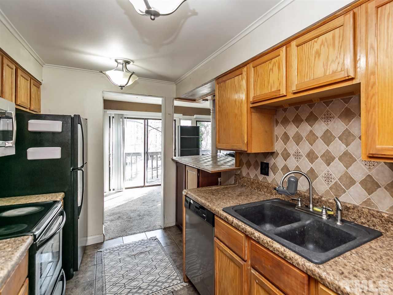 1722 Quail Ridge Road Raleigh, NC 27609 - Photo 5 of 28 a kitchen with a sink stove and cabinets