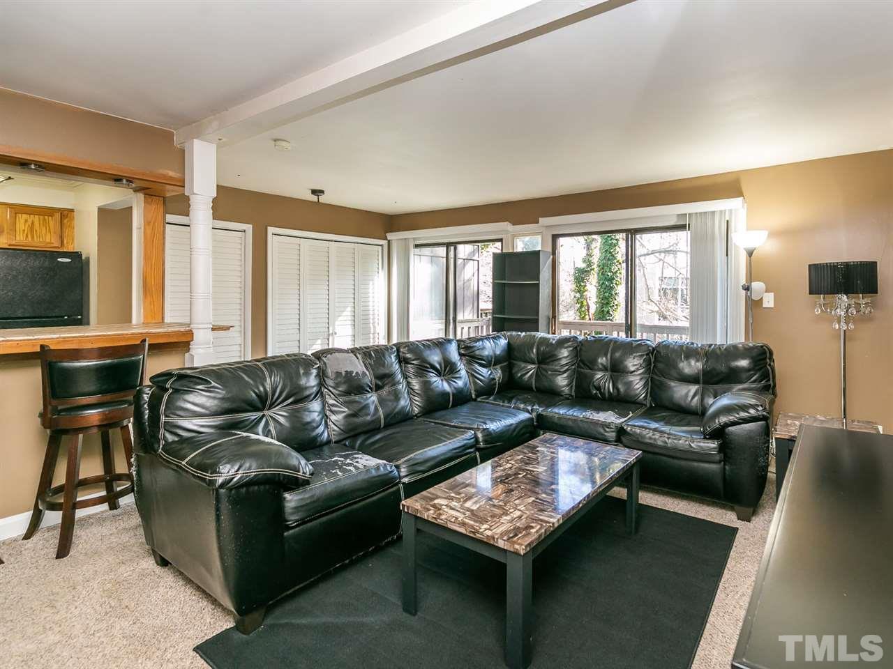 1722 Quail Ridge Road Raleigh, NC 27609 - Photo 7 of 28 a living room with furniture and a flat screen tv