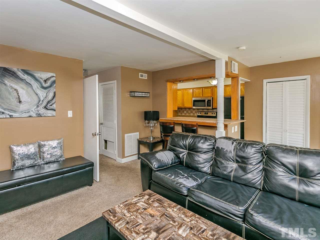 1722 Quail Ridge Road Raleigh, NC 27609 - Photo 9 of 28 a living room with furniture and a flat screen tv