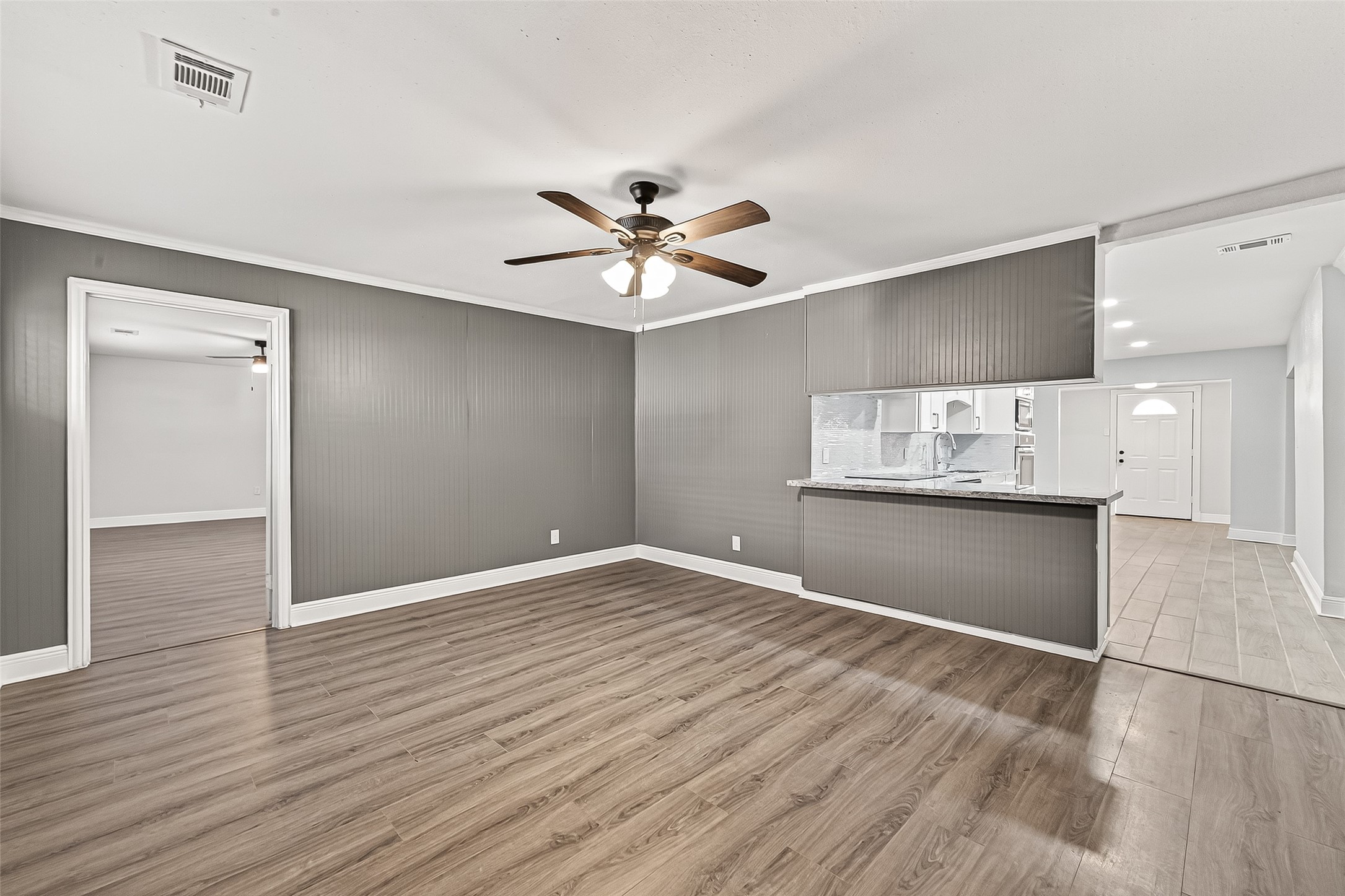 4729 Paradise Lane Houston, TX 77048 - Photo 25 of 43 a view of kitchen and empty room with wooden floor