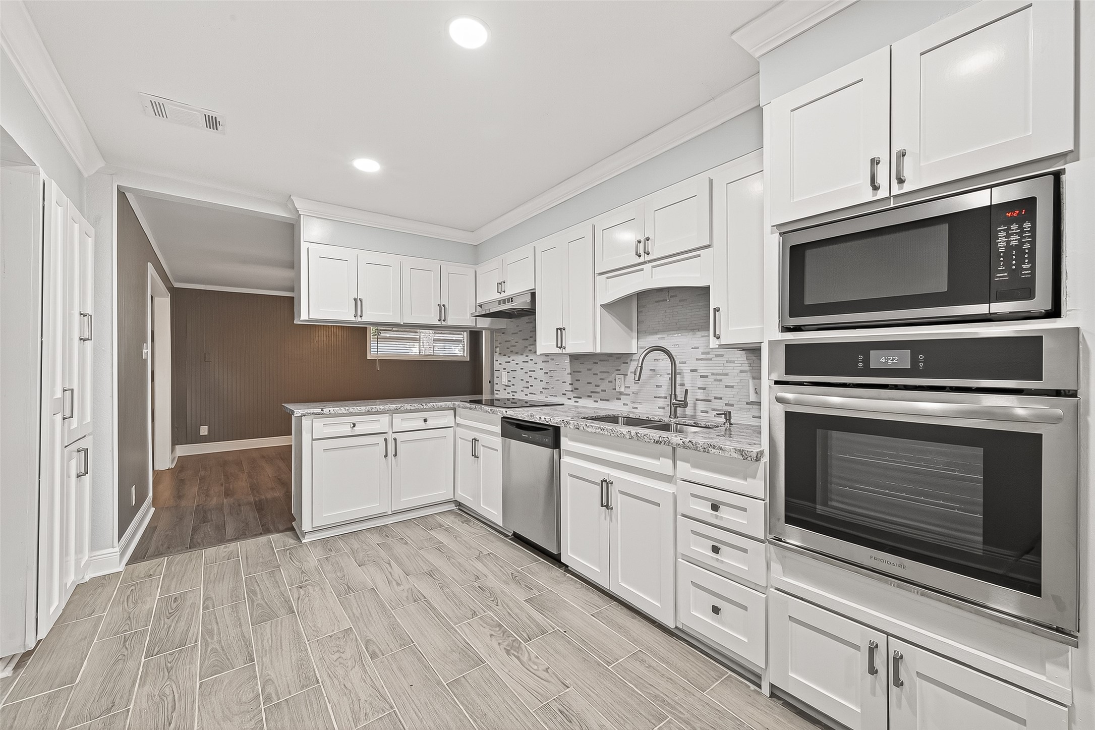 4729 Paradise Lane Houston, TX 77048 - Photo 36 of 43 a kitchen with granite countertop cabinets stainless steel appliances and wooden floor
