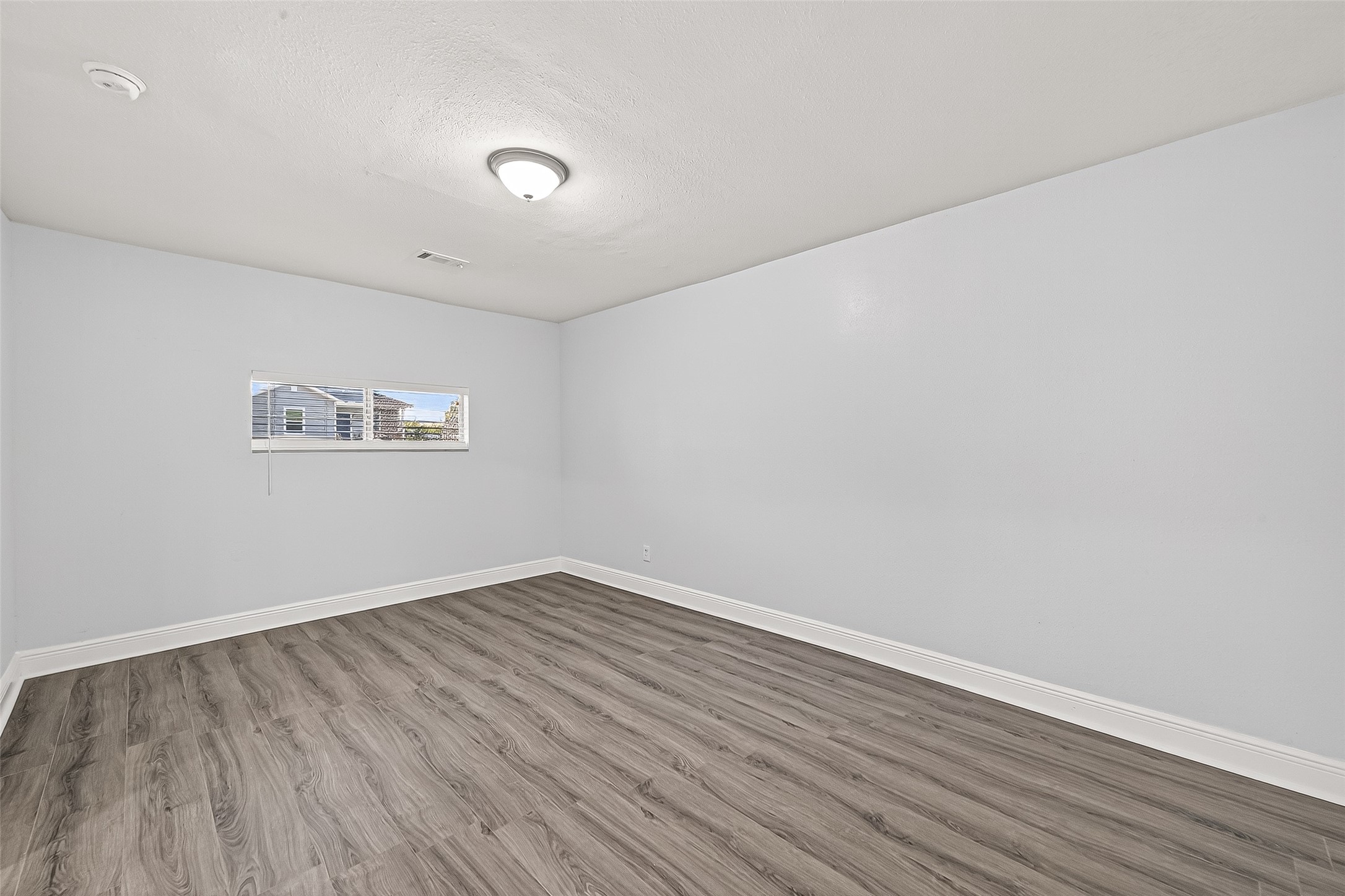 4729 Paradise Lane Houston, TX 77048 - Photo 4 of 43 a view of a room with wooden floor and white walls