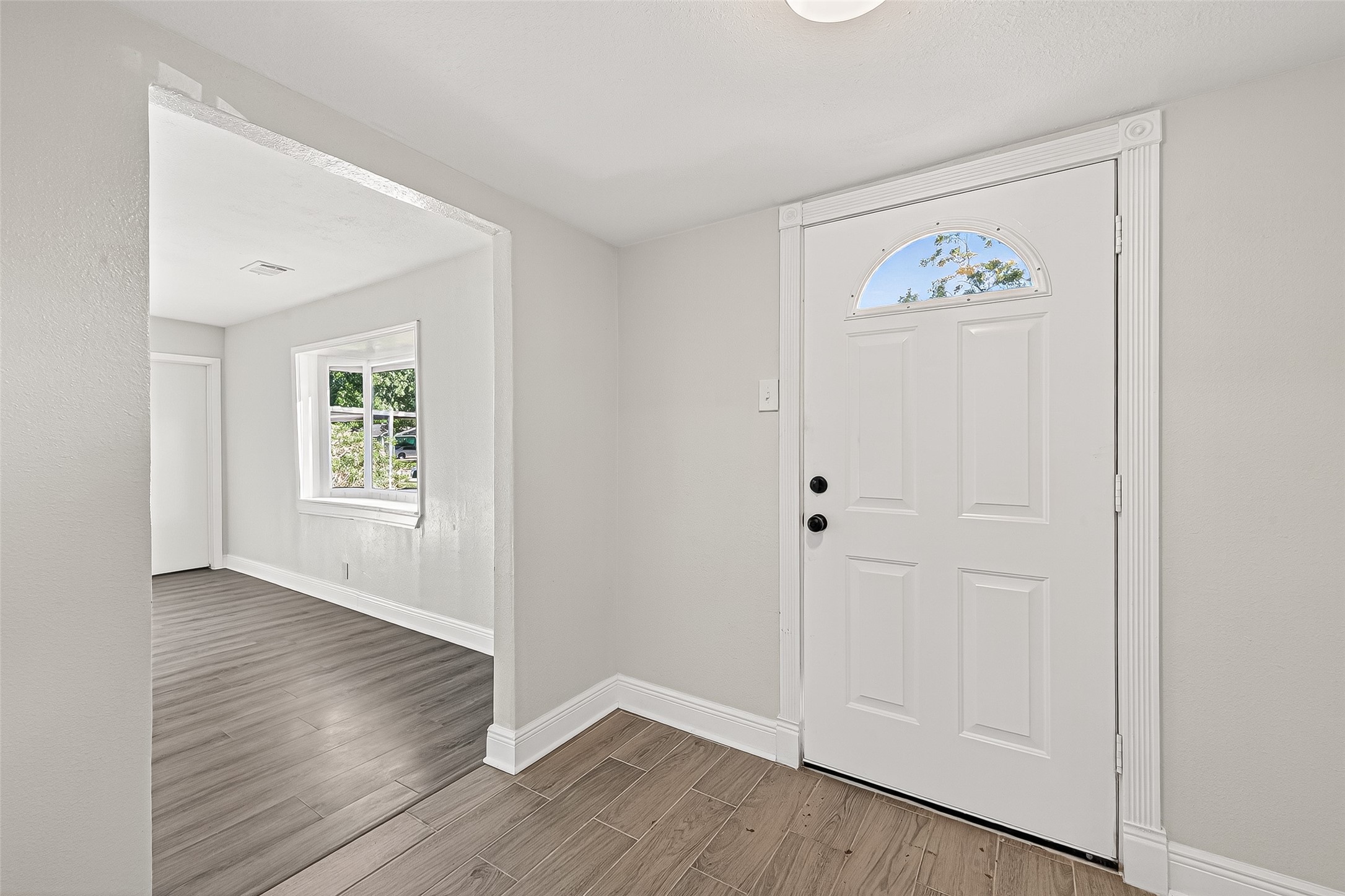 4729 Paradise Lane Houston, TX 77048 - Photo 7 of 43 an empty room with wooden floor and window