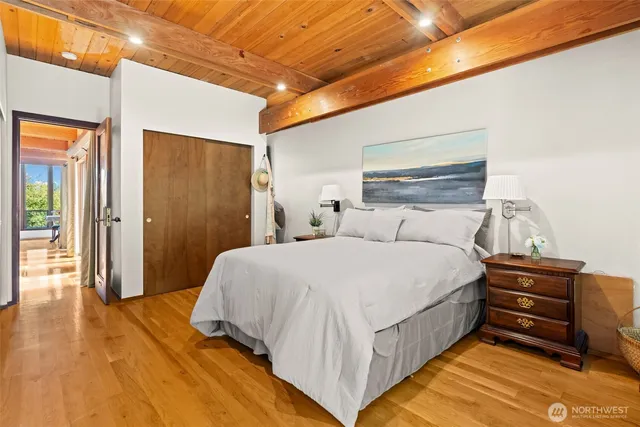 a bedroom with a bed and a wall painting