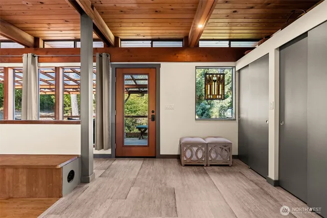 a dining room with furniture and a large window