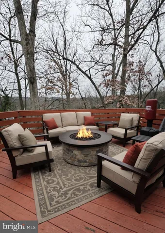 a outdoor living space with patio furniture and a fireplace