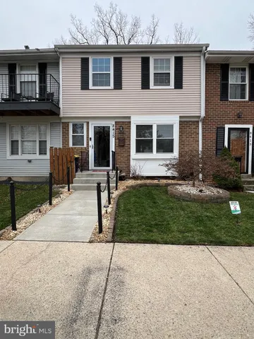 a front view of a house with a yard and outdoor seating