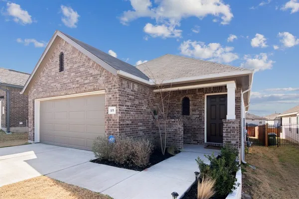 a front view of a house with yard