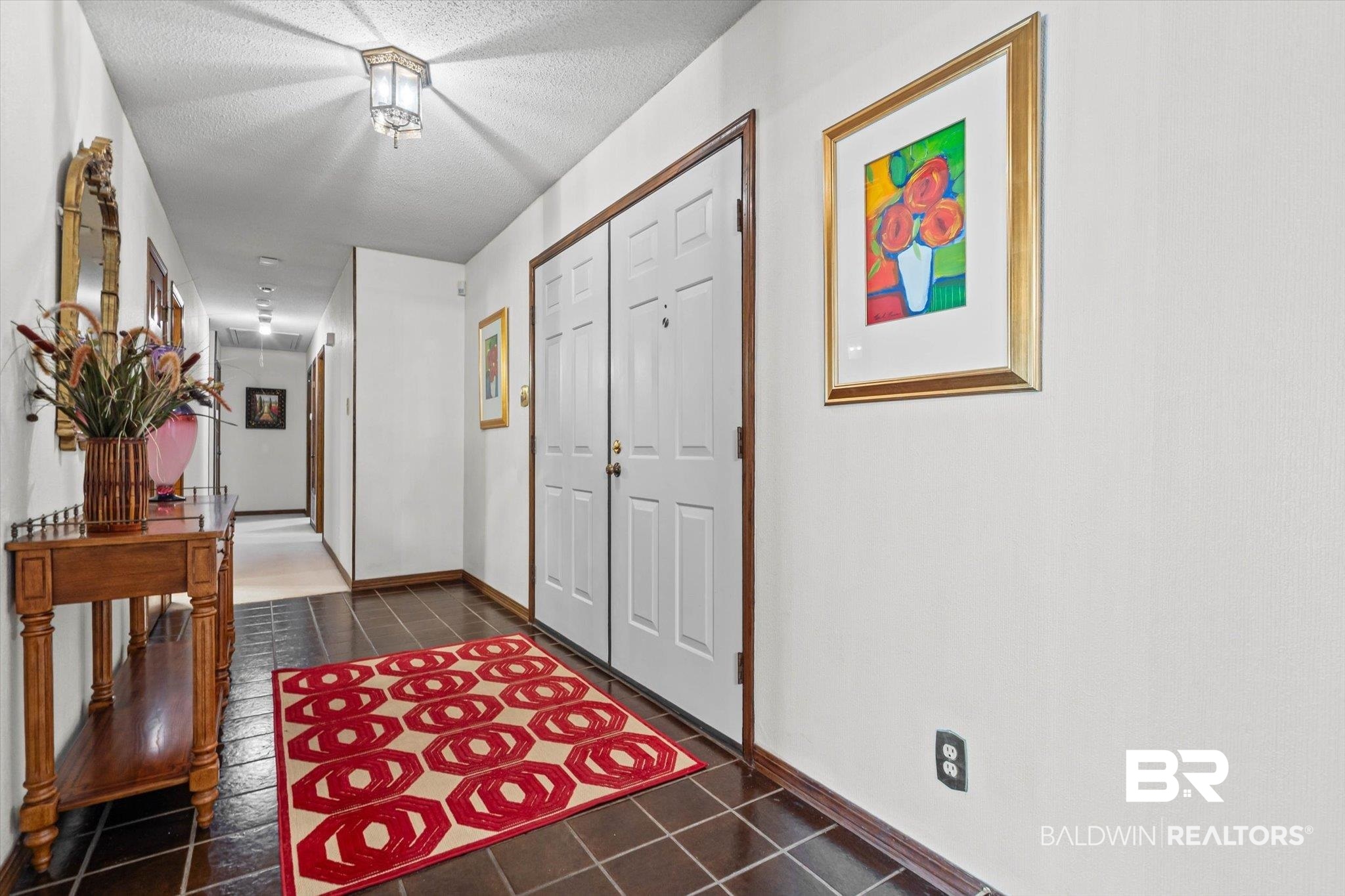 1900 Foxfire Road Mobile, AL 36618 - Photo 4 of 36 Foyer entrance featuring a textured ceiling and dark tile patterned floors