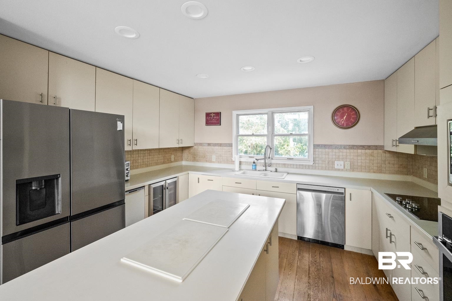 29255 Ono Boulevard Orange Beach, AL 36561 - Photo 26 of 43 Kitchen with stainless steel appliances, wine cooler, cream cabinetry, backsplash, and recessed lighting