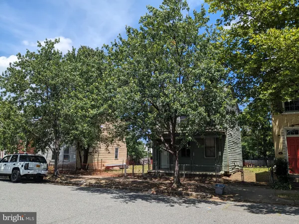 a couple of cars parked in front of a house