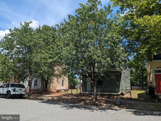 a couple of cars parked in front of a house