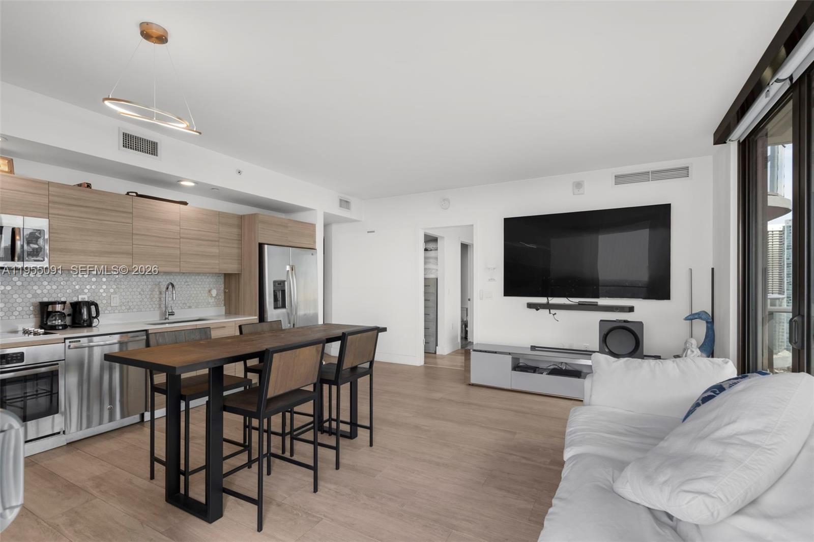 121 Northeast 34th Street, Unit 3001 Miami, FL 33137 - Photo 4 of 13 a view of a livingroom with furniture and a flat screen tv