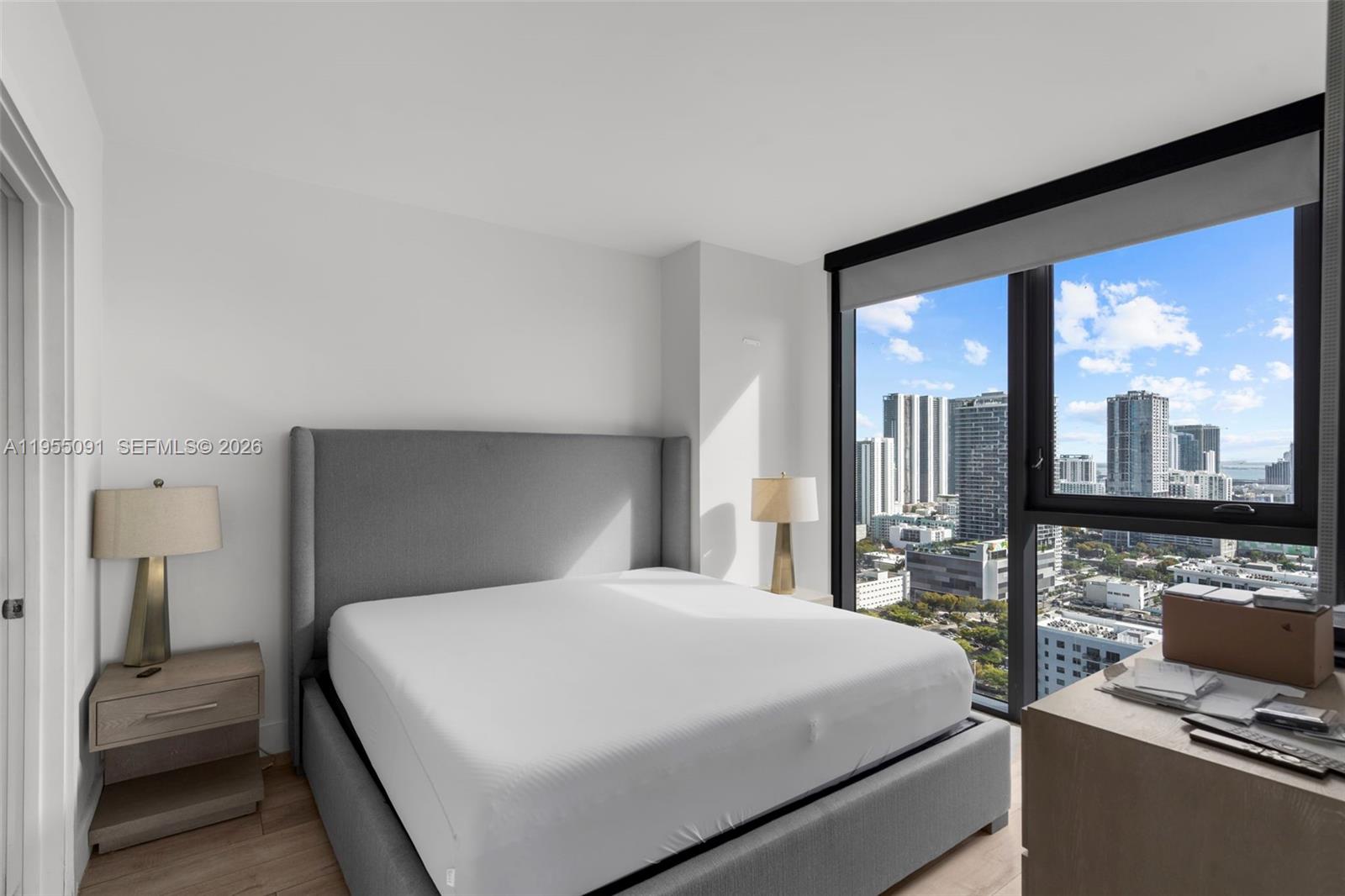 121 Northeast 34th Street, Unit 3001 Miami, FL 33137 - Photo 5 of 13 a bedroom with a large bed and a large window