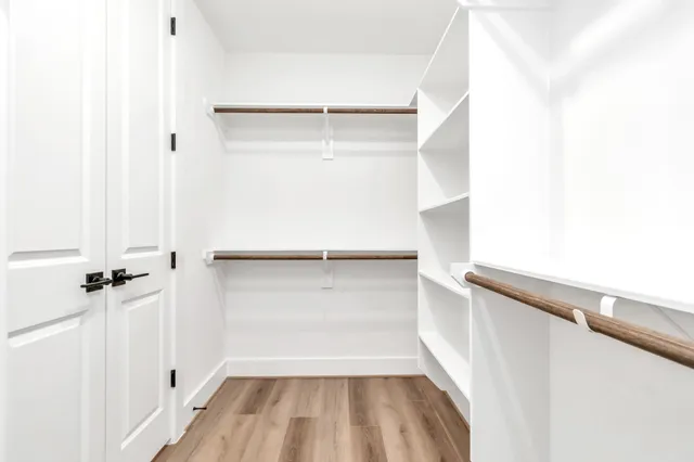 a view of walk in closet with empty racks