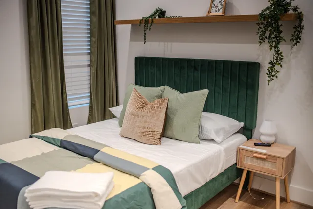 a bedroom with a bed and a chair