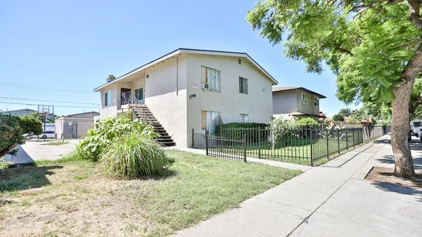 a front view of house with a garden