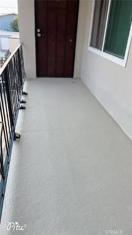 a bed sitting in a kitchen next to a window