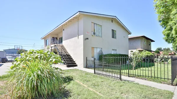 a view of a house with a yard and plants