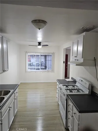 closeup of a sink a stove and washer