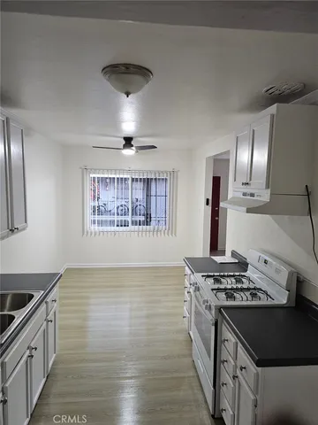 closeup of a sink a stove and washer