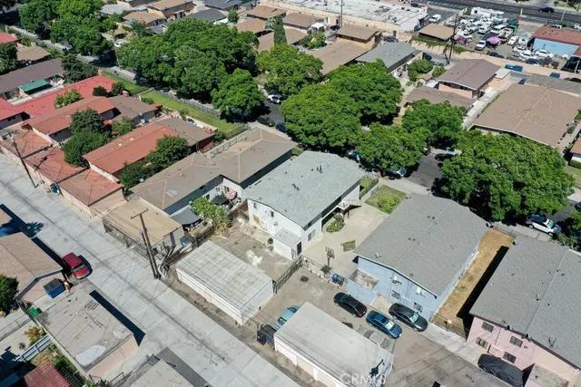 an aerial view of residential houses with outdoor space and parking