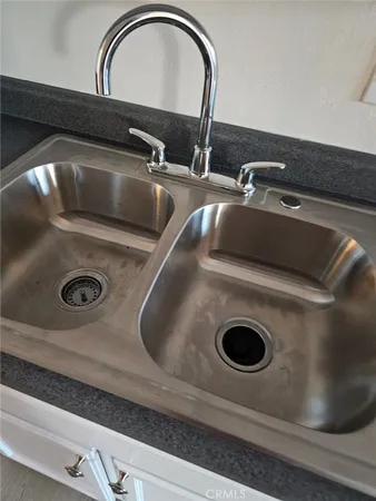 a view of a room with wooden floor and a window