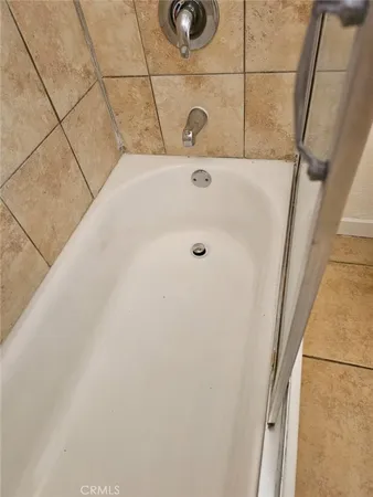 an aerial view of residential houses with outdoor space and parking