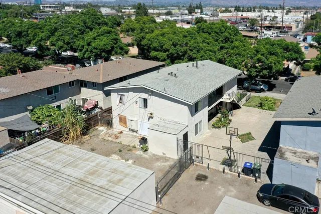 an aerial view of a house with a yard and seating area