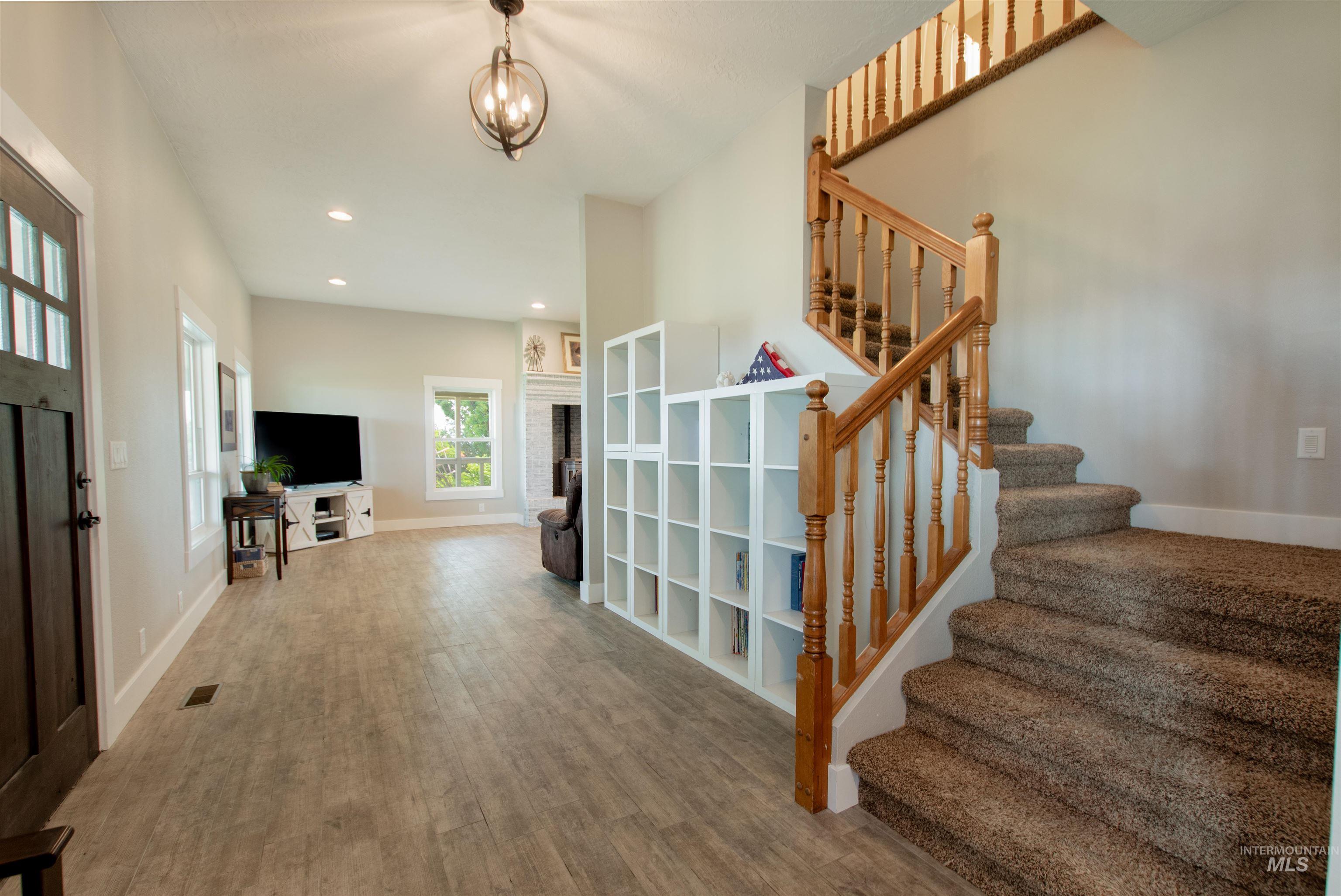 12369 Deer Flat Road Nampa, ID 83686 - Photo 12 of 50 White-painted brick fireplace with a built-in stove insert