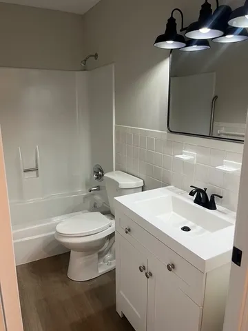 a bathroom with a sink toilet and mirror