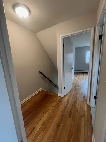 a view of hallway with wooden floor