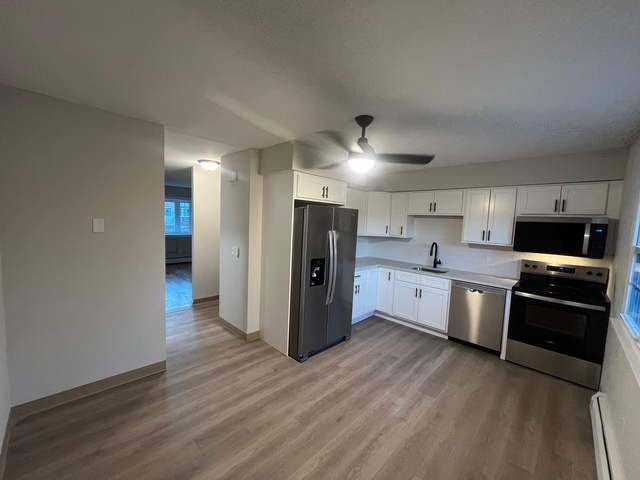 79 Beths Avenue, Unit 100 Bristol, CT 06010 - Photo 5 of 29 a kitchen with stainless steel appliances granite countertop a refrigerator and a stove top oven