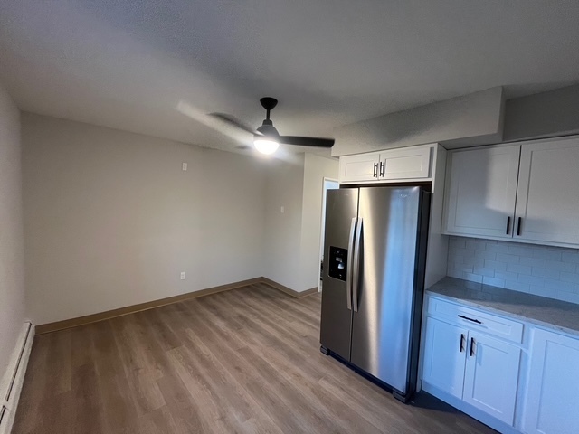 79 Beths Avenue, Unit 100 Bristol, CT 06010 - Photo 6 of 29 a view of a kitchen with wooden floor refrigerator and cabinet