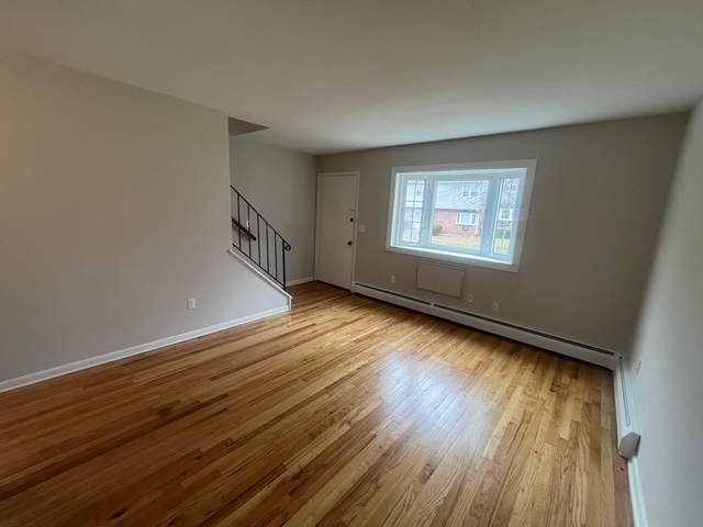 79 Beths Avenue, Unit 100 Bristol, CT 06010 - Photo 8 of 29 a view of an empty room with wooden floor and a window
