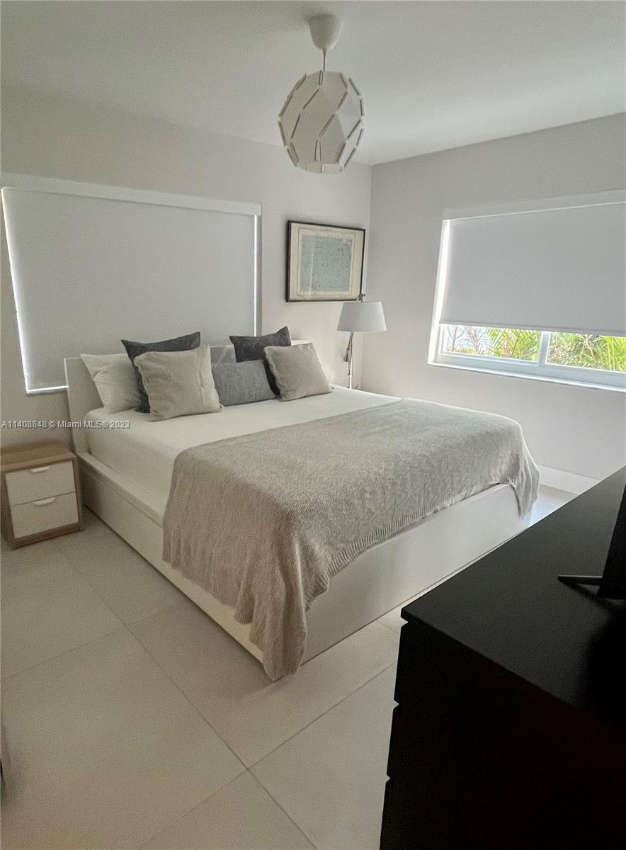 337 Southwest 23rd Road, Unit 1 Miami, FL 33129 - Photo 12 of 31 a bedroom with a bed and window