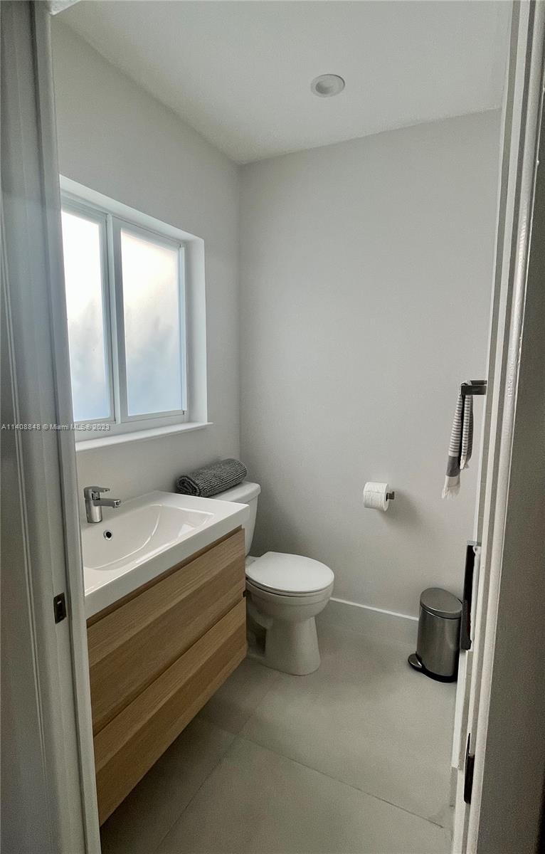 337 Southwest 23rd Road, Unit 1 Miami, FL 33129 - Photo 14 of 31 a bathroom with a toilet sink and mirror
